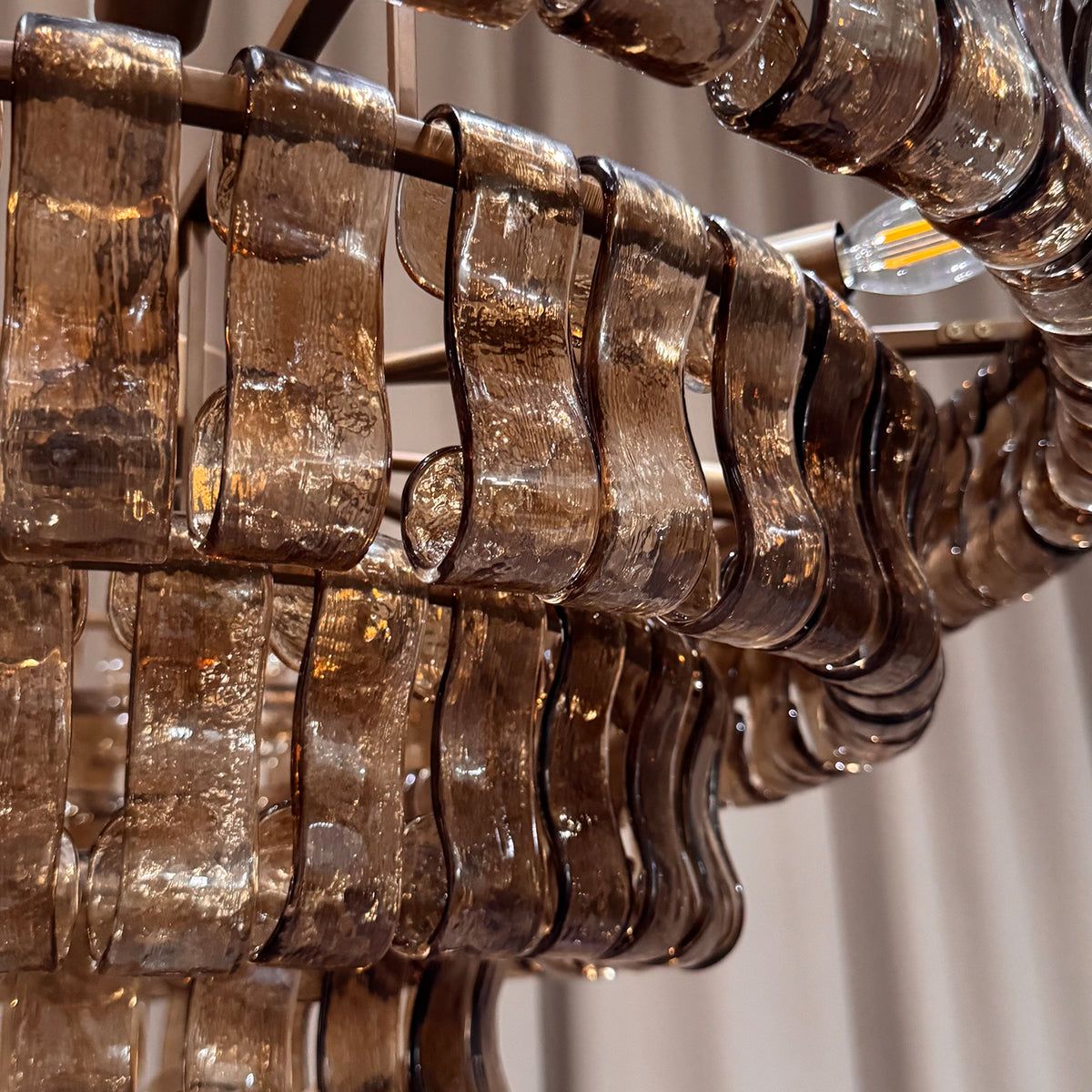 Detail of glass panels suspended from the chandelier metal frame