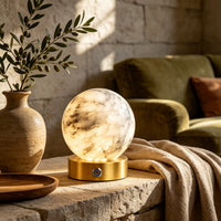 Alabaster globe table lamp on a stone side table in a living room