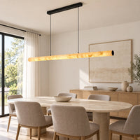Aurelia linear alabaster pendant with black suspension above an oval dining table in a neutral dining room