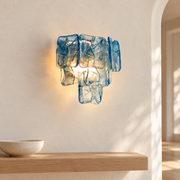 Marea Fold blue glass and silver frame wall sconce in a bright entryway scene